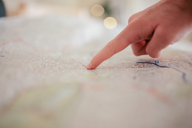 person pointing at a spot on a map